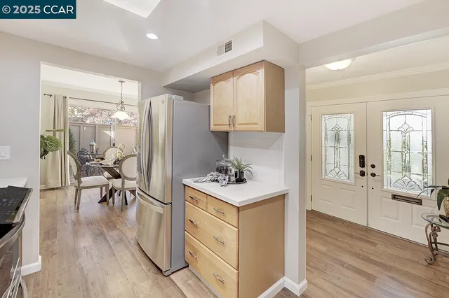 a view of a livingroom with wooden floor and furniture