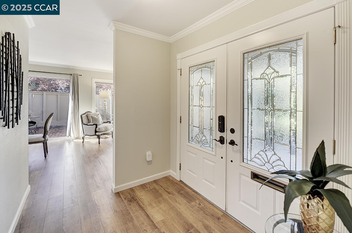 2424 Tice Creek Drive, Unit 2 Walnut Creek, CA 94595 - Photo 17 of 54 a view of a livingroom with wooden floor and furniture
