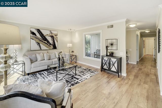 a view of a dining room with furniture wooden floor and chandelier