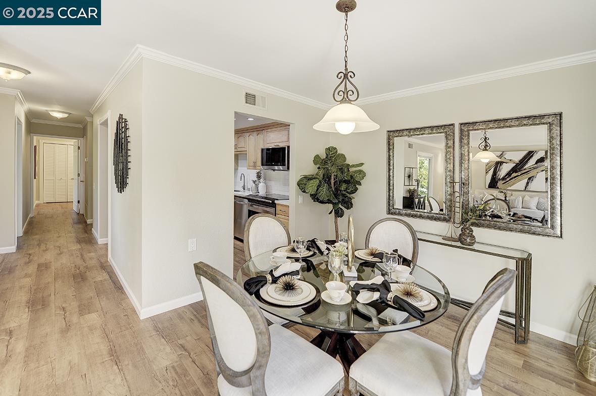 2424 Tice Creek Drive, Unit 2 Walnut Creek, CA 94595 - Photo 19 of 54 a view of a dining room with furniture wooden floor and chandelier