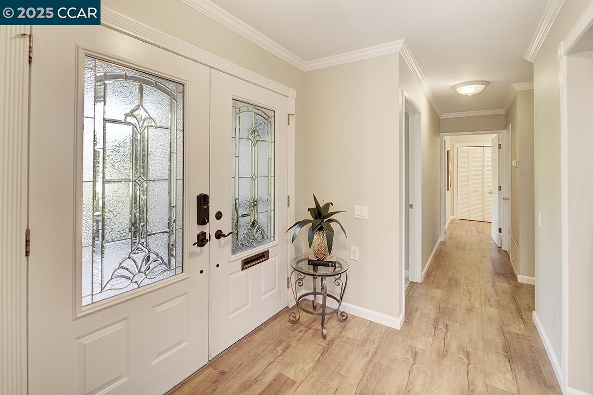 2424 Tice Creek Drive, Unit 2 Walnut Creek, CA 94595 - Photo 20 of 54 a view of a hallway with wooden floor and a living room