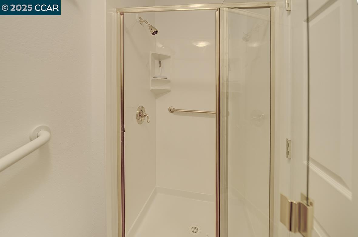 2424 Tice Creek Drive, Unit 2 Walnut Creek, CA 94595 - Photo 35 of 54 a bathroom with a glass shower door