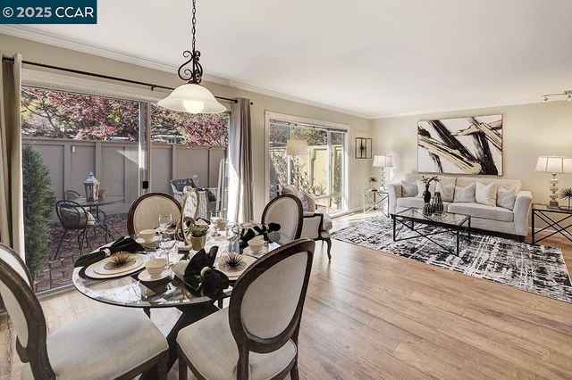 a living room with furniture a chandelier and a large mirror