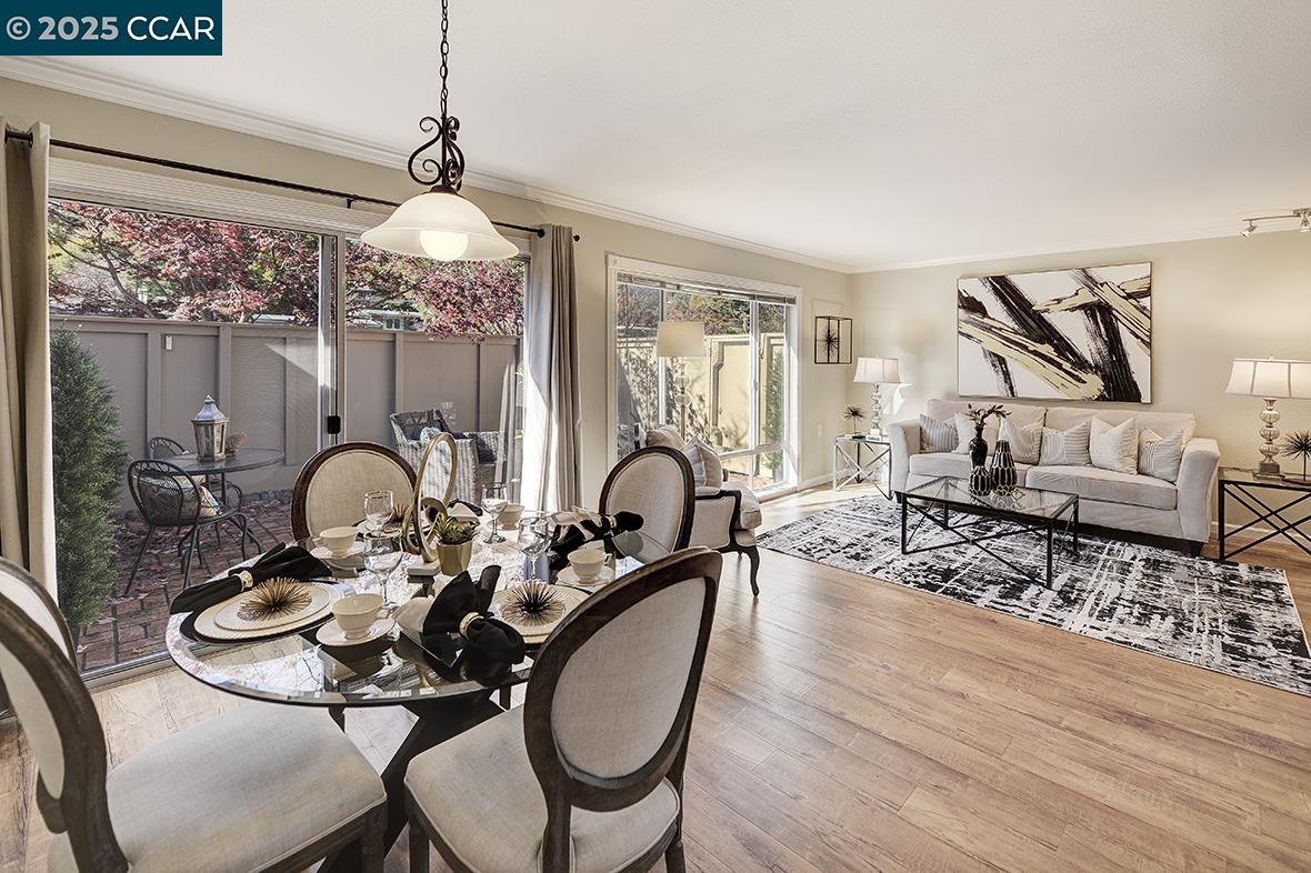 2424 Tice Creek Drive, Unit 2 Walnut Creek, CA 94595 - Photo 5 of 54 a living room with furniture a chandelier and a large mirror