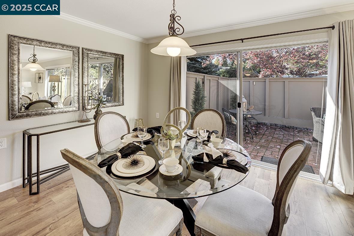 2424 Tice Creek Drive, Unit 2 Walnut Creek, CA 94595 - Photo 6 of 54 a dining room with furniture wooden floor and a chandelier