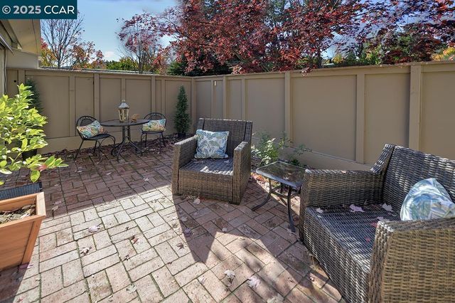 a dining room with furniture and a potted plant