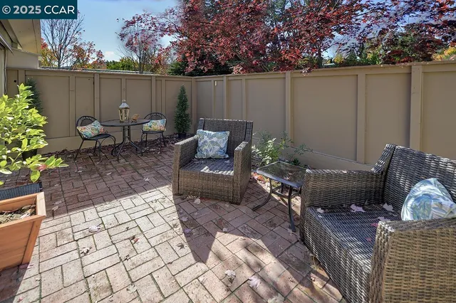 a dining room with furniture and a potted plant