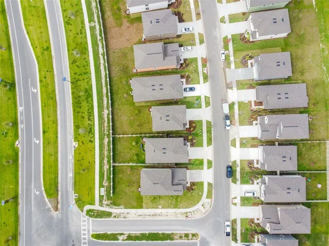 an aerial view of residential house with outdoor space and parking