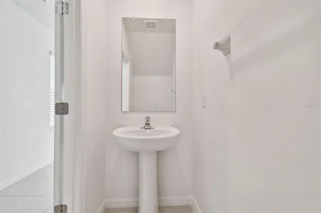 a bathroom with a sink a mirror and vanity