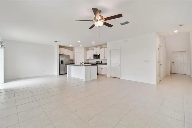 a view of a kitchen with a sink and a refrigerator