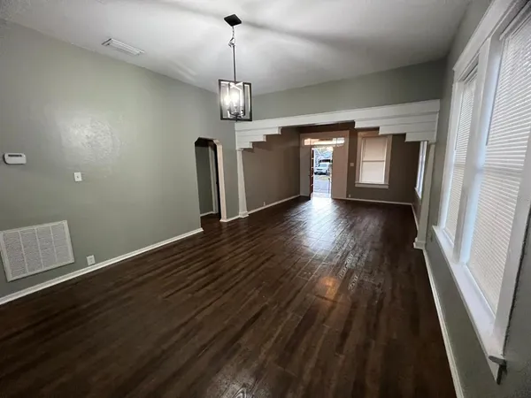 a view of a room with wooden floor and window