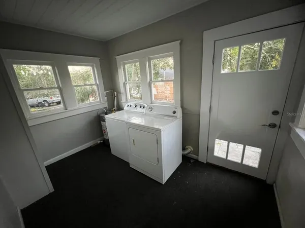 an empty room with an entryway and wooden floor
