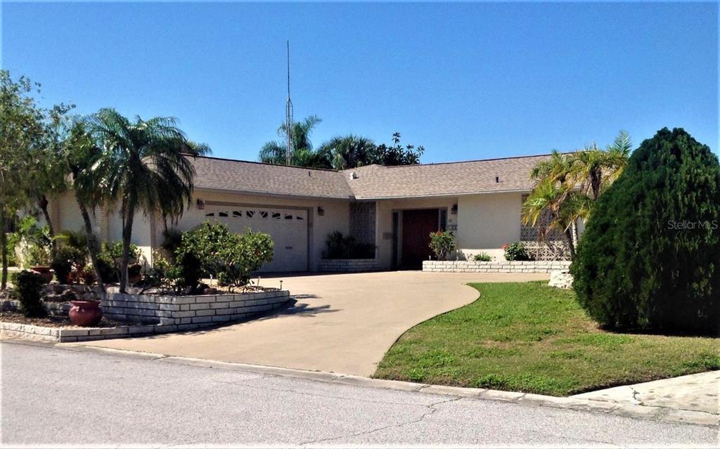 5331 Pilots Place New Port Richey, FL 34652 - Photo 1 of 1 a front view of a house with garden and porch