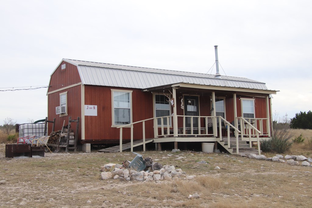 Lot 11 Other Rocksprings, TX 78880 - Photo 2 of 10 a front view of a house with a balcony