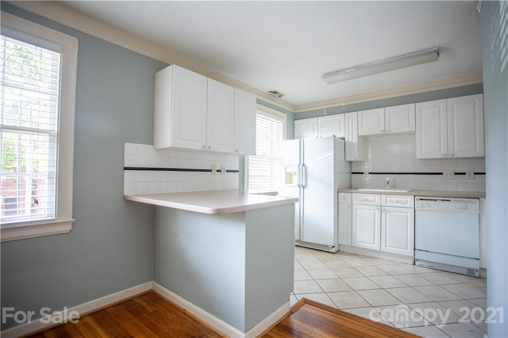 104 Colville Road, Unit 42A Charlotte, NC 28207 - Photo 14 of 19 a kitchen with white cabinets and white appliances