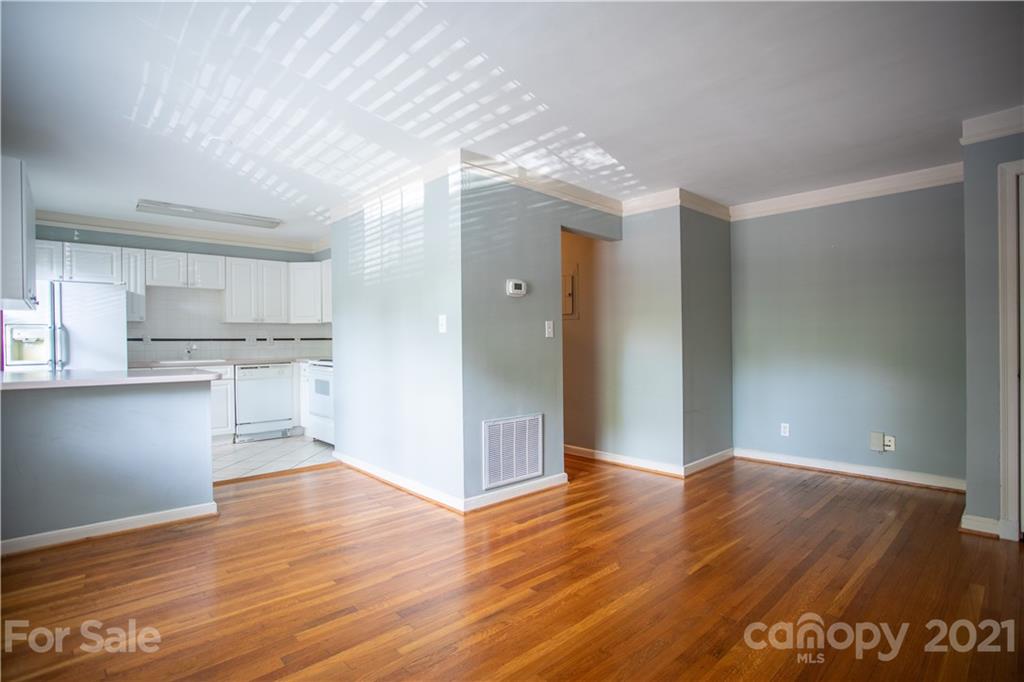 104 Colville Road, Unit 42A Charlotte, NC 28207 - Photo 3 of 19 a view of a kitchen with wooden floor and a kitchen