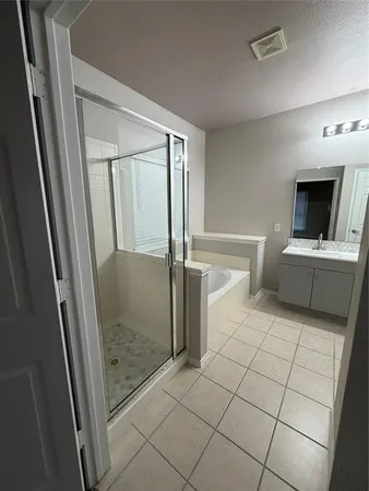 a view of a hallway view with furniture and a bathroom
