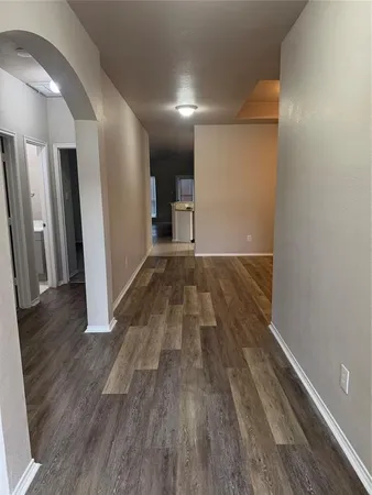 a view of hallway with wooden floor