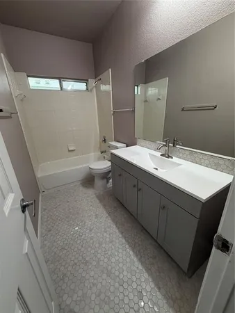 a bathroom with a double vanity sink toilet mirror and bathtub