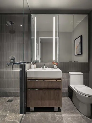 a bathroom with a sink a toilet and shower