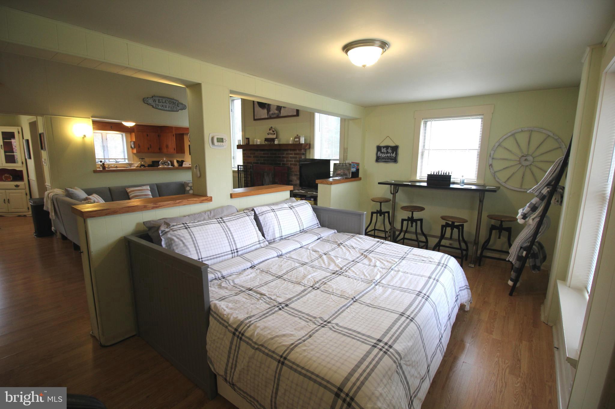 48 Poor Farm Road, Unit COTTAGE Pennington, NJ 08534 - Photo 14 of 34 a bedroom with a bed and wooden floor