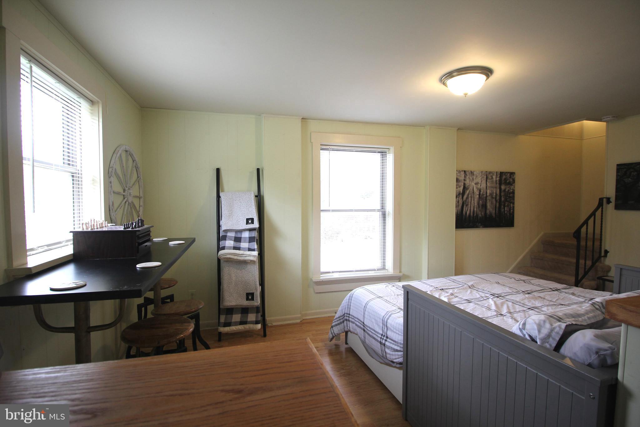 48 Poor Farm Road, Unit COTTAGE Pennington, NJ 08534 - Photo 15 of 34 a bedroom with a bed and a window
