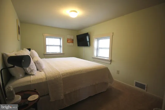 a bed sitting in a bedroom next to a window