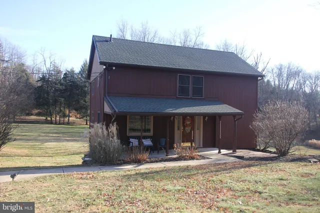 a view of a house with backyard porch and sitting area