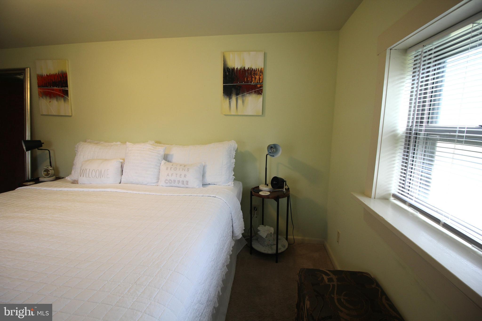 48 Poor Farm Road, Unit COTTAGE Pennington, NJ 08534 - Photo 21 of 34 a bedroom with a bed and a window