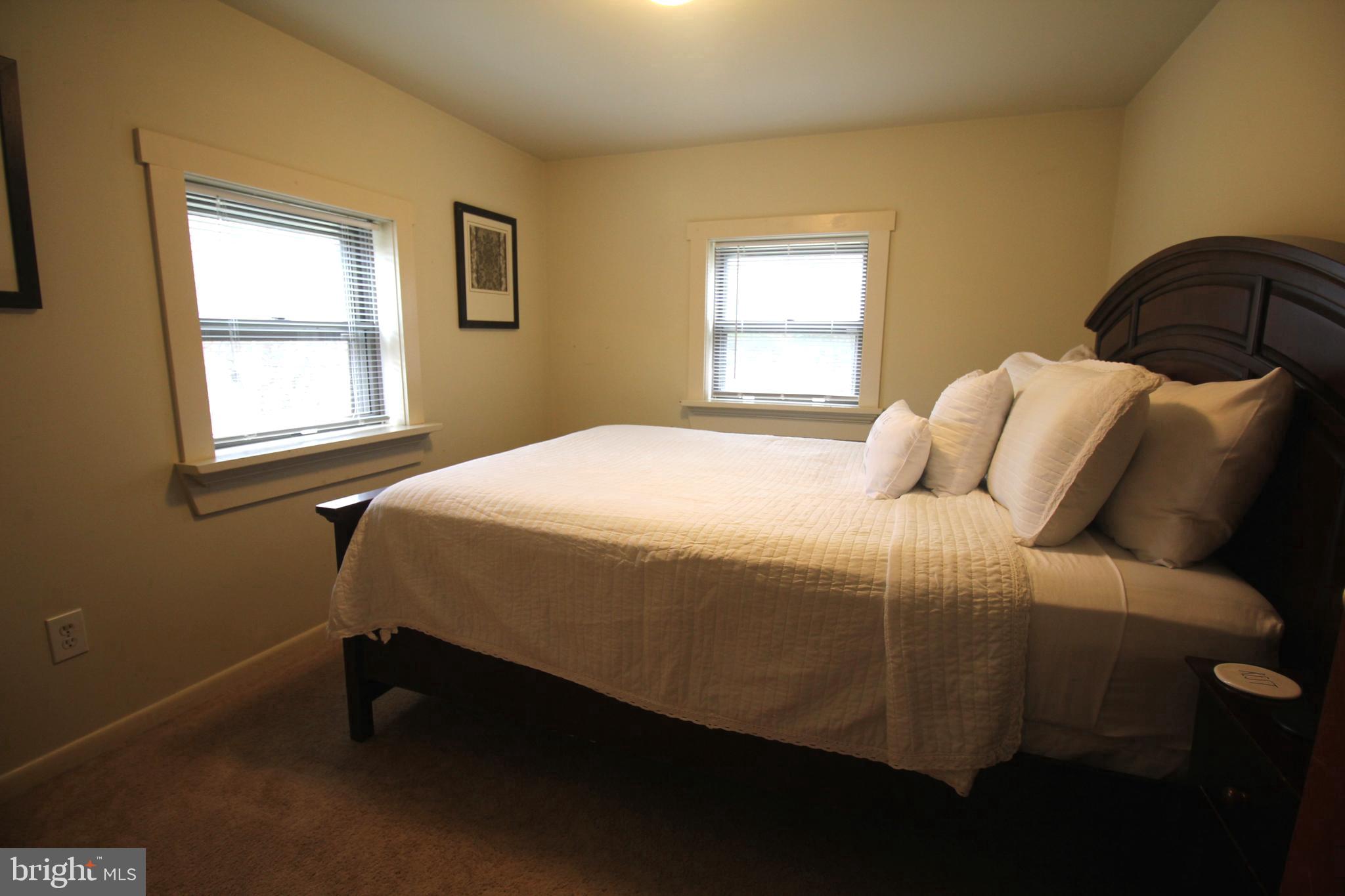 48 Poor Farm Road, Unit COTTAGE Pennington, NJ 08534 - Photo 23 of 34 a bedroom with a bed and window