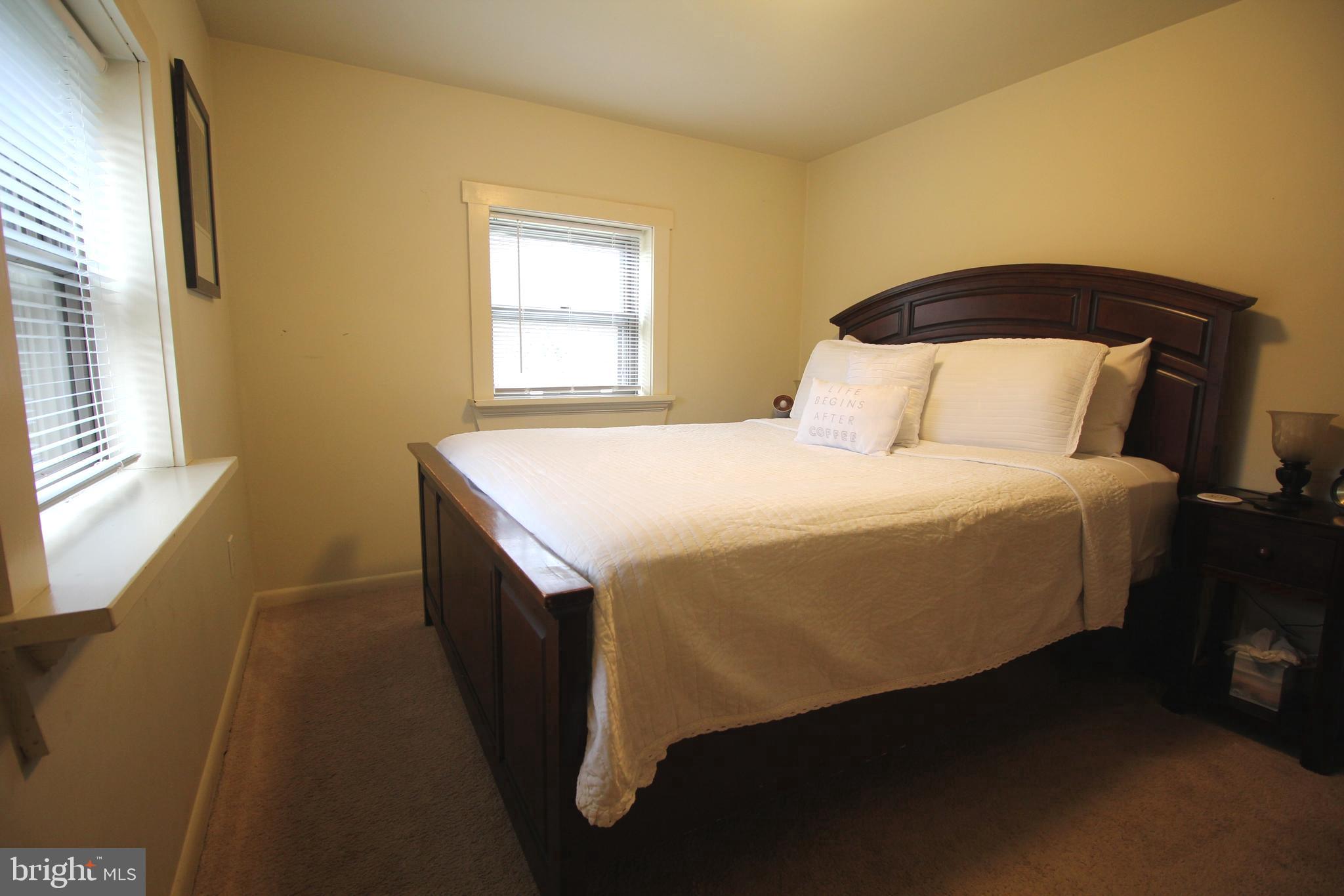 48 Poor Farm Road, Unit COTTAGE Pennington, NJ 08534 - Photo 24 of 34 a bedroom with a bed and a window