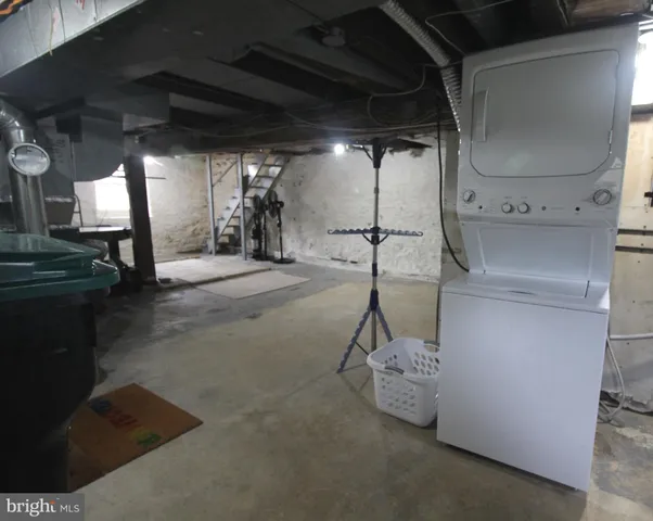 a room with stainless steel appliances kitchen island a table and chairs in it