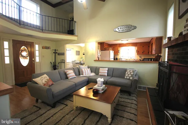 a living room with furniture a rug and wall painting