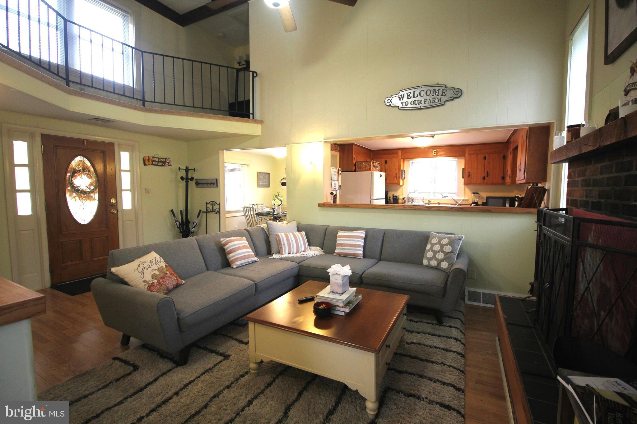 48 Poor Farm Road, Unit COTTAGE Pennington, NJ 08534 - Photo 6 of 34 a living room with furniture a rug and wall painting