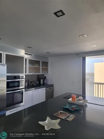 a kitchen with granite countertop a stove and a refrigerator