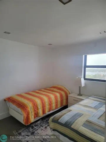 a bedroom with two beds and painted walls