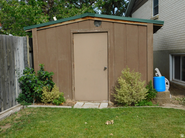 2148 Carolyn Way Bountiful, UT 84010 - Photo 29 of 40 Freestanding storage shed with a brown wood-paneled exterior and a green roof
