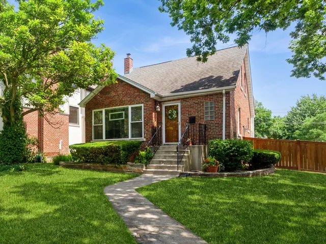 a view of house with a yard and plants