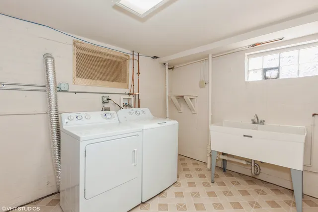 a utility room with cabinets washer and dryer