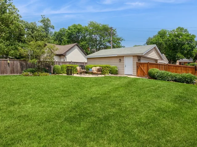 a front view of a house with a yard and green space
