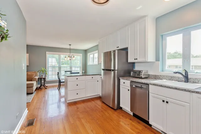 a kitchen with white cabinets and white appliances