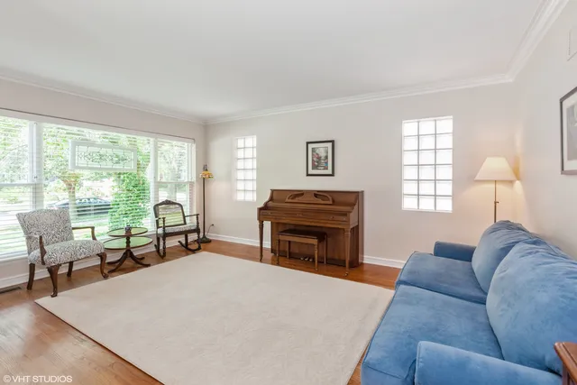 a living room with furniture a fireplace and a large window