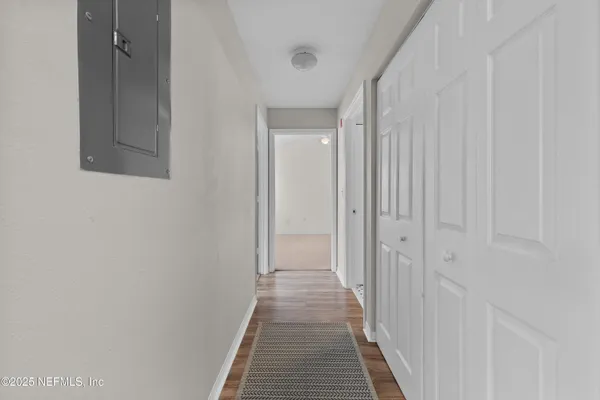a view of a hallway with wooden floor