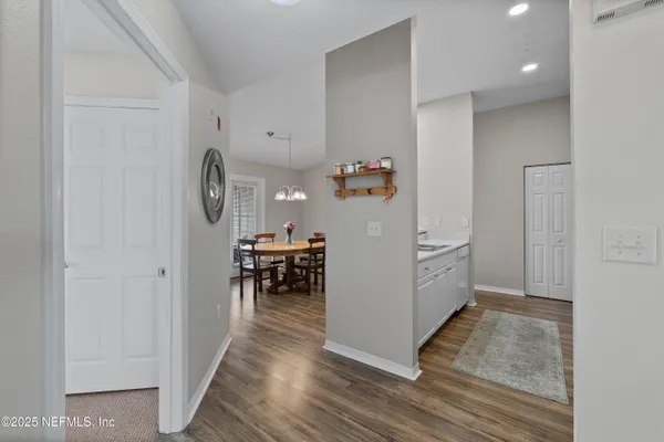 a kitchen with refrigerator and cabinets