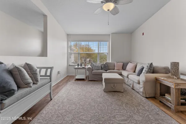 a living room with furniture and a large window