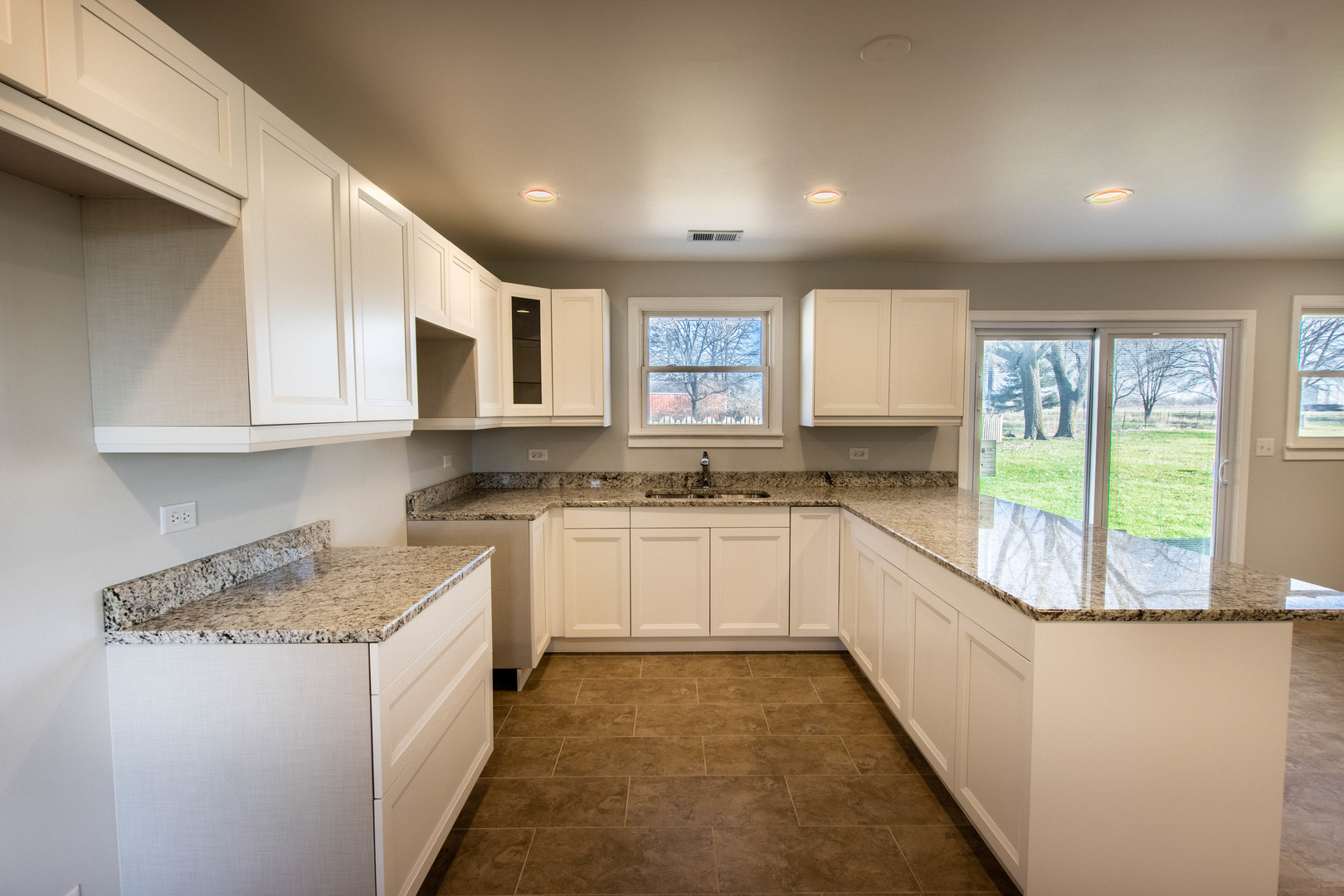 25955 South Tehle Road Elwood, IL 60421 - Photo 3 of 22 a kitchen with granite countertop white cabinets and white appliances