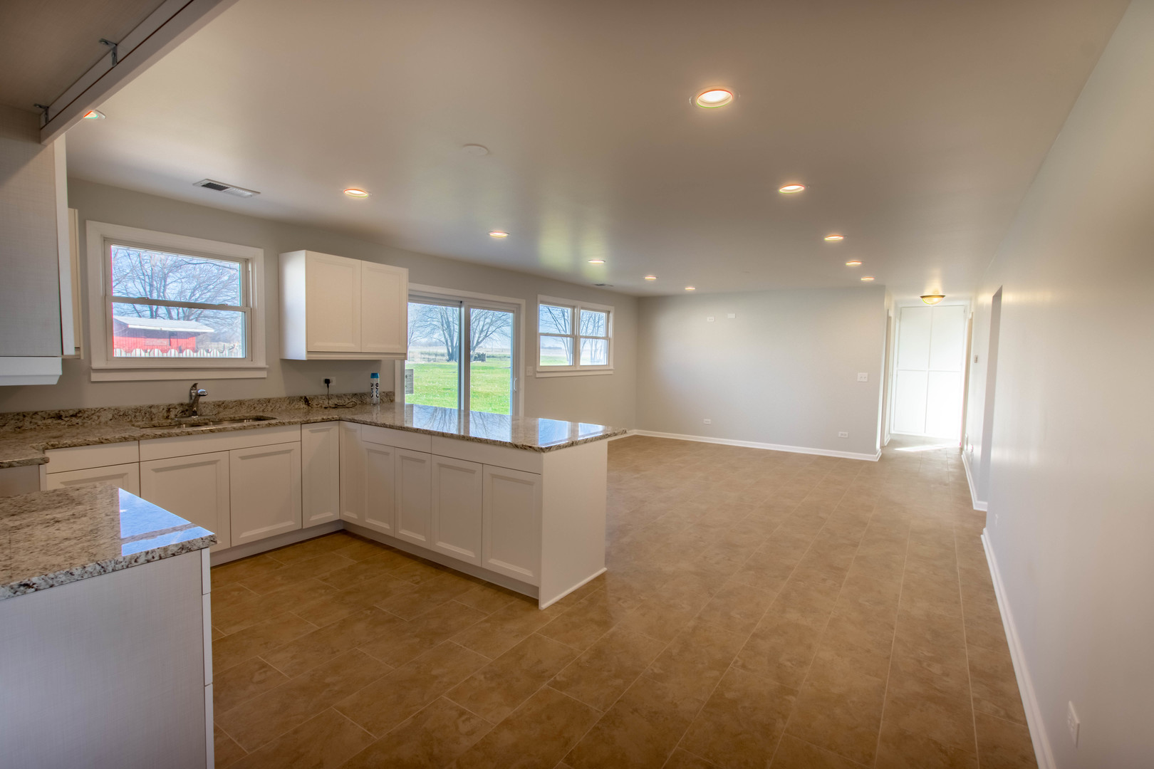 25955 South Tehle Road Elwood, IL 60421 - Photo 4 of 22 a large white kitchen with a sink and dishwasher a stove top oven with wooden floor