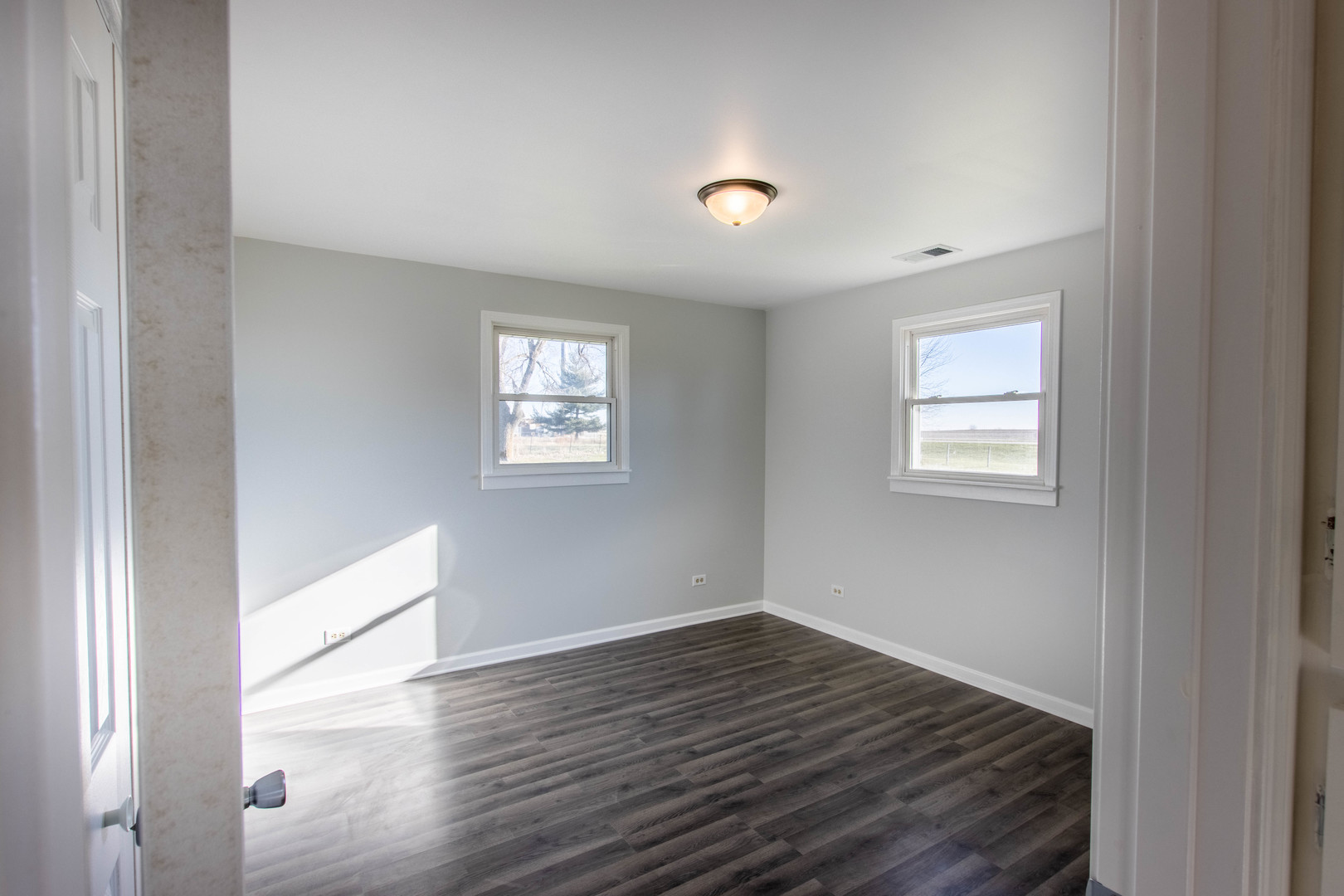 25955 South Tehle Road Elwood, IL 60421 - Photo 9 of 22 a view of an empty room with wooden floor and a window