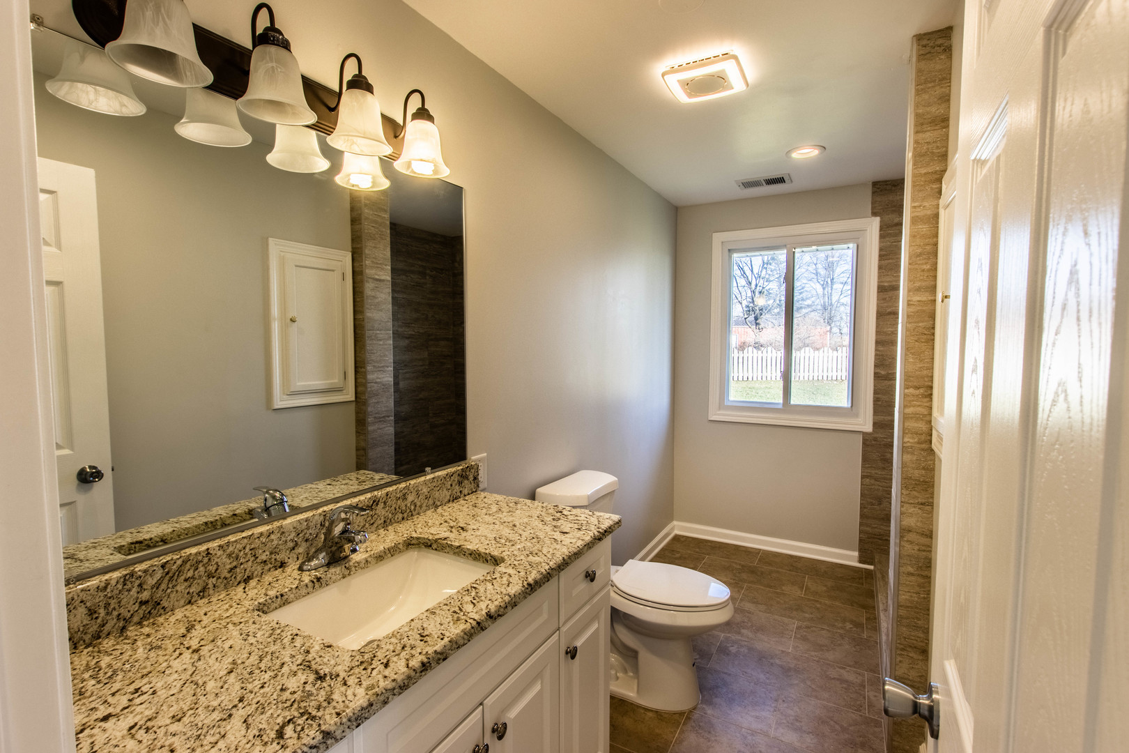 25955 South Tehle Road Elwood, IL 60421 - Photo 10 of 22 a bathroom with a granite countertop sink a toilet and a mirror