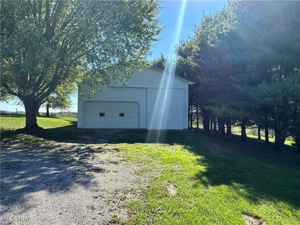 59558 Sandy Ridge Road Barnesville, OH 43713 - Photo 6 of 46 View of outbuilding with a garage and a lawn